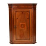A 19th century inlaid mahogany wall mounted corner cupboard, 82cms (32ins) wide.