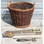 A set of brass fire irons and a wicker log basket