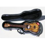 A Cursley Vodkalele ukulele, number T002, dated 7/09/2010, cased, 65cms (25.5ins) long.