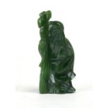 A Chinese jade figure of an Immortal holding a staff, 8cms (3ins) high.