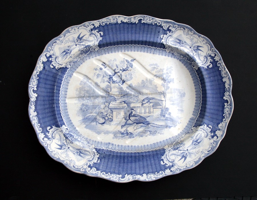 A large 19th century blue & white transfer printed meat plate with gravy well, decorated with