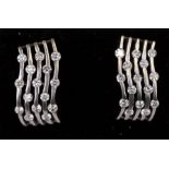 A pair of 18ct white gold modern design diamond set earrings. 3.7g