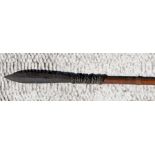 A tribal hardwood blow pipe with steel spear tip, 185cms (73ins) long.