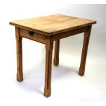 A stripped pine table with single frieze drawer, on square chamfered legs, 89cms (35ins) long.