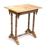 A stripped pine occasional table on turned twin supports joined by a stretcher, 64cms (25ins) wide.