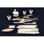 A group of 19th century bone and ivory sewing tools to include tatting shuttles and sewing clamp.