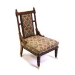A late 19th / early 20th century walnut upholstered nursing chair.
