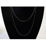 An 18ct white gold necklace; together with an 18ct white and yellow gold ball and link necklace,