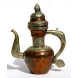 A Tibetan brass and copper teapot, 23cms (9ins) high.