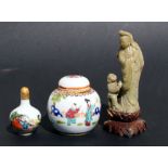 A Chinese soapstone figural group depicting a robed lady with a young boy, 20cms (8isn) high;