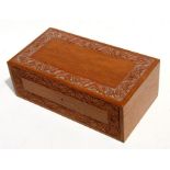 A carved teak jewellery box, 34cms (13.5ins) wide.