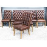 A set of eight modern button backed dining chairs upholstered in brown leather.