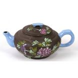 A Chinese Yixing teapot decorated with flowers in enamel colours, impressed seal mark to the