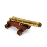 A bronze model of a cannon W. North. 1848, on a later carriage, 23cms (9ins) long.