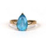 A 9ct gold dress ring set with a pale blue pear shaped stone, approx UK size 'P'. 1.9g
