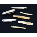 A group of penknives; together with a 19th century miniature ivory cut-throat razor.