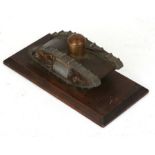 A WW1 brass and aluminium trench art Tank with machine guns and rotating turret mounted on a