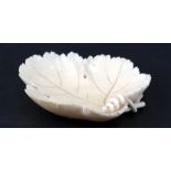 A 19th century European ivory carved bowl in the form of a vine leaf, 10cms (4ins) long.