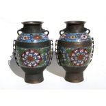 A pair of Chinese two-handled bronze vases with enamel decoration, 30cms (12ins) high.