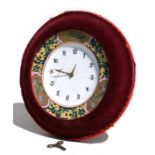 An Arts & Crafts porcelain, oak and velvet covered strut clock, the white dial with Arabic numerals,