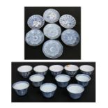 A group of Chinese blue & white tea bowls decorated with flowers, 5cms (2ins) high; together with