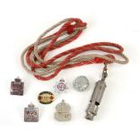 A WW2 Air Raid Precautions whistle on a cord lanyard together with various WW2 badges including ARP,