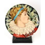 A Minton hand decorated earthenware plate by Ellen Welby, decorated with a young man wearing a ruff,