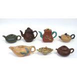 A group of Chinese Yixing pottery teapots to include a green compressed melon form example and a