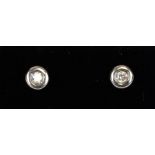A pair of 9ct white and yellow gold diamond stud earrings.