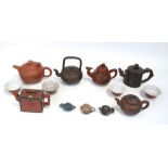 A group of Yixing pottery teapots to include one with an articulated dragon head finial and three