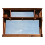 A walnut overmantle mirror, 121cms (47.5ins) wide.