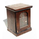 A Victorian mahogany microscope slide cabinet, the arched glazed door enclosing twenty drawers,
