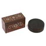 A turned treen snuff box, 9.5cms (3.75ins) diameter; together with a mother of pearl inlaid