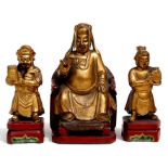 A group of three Chinese gilded wooden figures, a dignitary with his attendants, 17cms (6.5ins) high