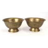 A pair of Chinese brass bowls decorated with dragons, six character mark to the underside, 26cms (