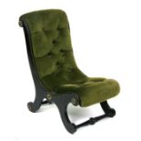A Victorian ebonised slipper chair with button upholstered seat.