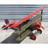 A large Fokker model tri-plane in 'Red Baron' colours, 125cms (49ins) long, 140cms (55ins) wide.