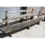 A pair of large well weathered rustic garden benches. each 244cm (96ins) wide.