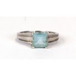 A modern design 9ct white gold ring set with a square aquamarine, approx UK size 'N'. 3.3g