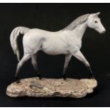 A Royal Doulton figure of a dapple grey horse on stand, 27cms (10.5ins) high.