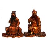 A pair of Chinese gilded wooden Immortals, each with an impressed wax collector's mark to the