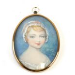 An oval portrait miniature depicting a young girl, 7 by 9.5cms (2.75 by 3.75ins).