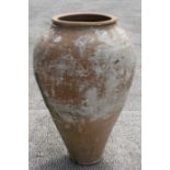 A large terracotta olive jar, 68cms (26.75ins) high.