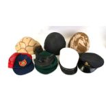 An assortment of eight Military helmets, caps, hats including two Green Berets (8)