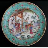 A Chinese famille rose plate with central panel decorated with ladies on a terrace within a