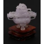 A Chinese lavender hardstone censer on three lion mask legs, 10cms (4ins) high.
