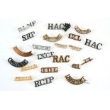 An assortment of twenty two Military shoulder titles including 12th Lancers, 3rd Dragoon Guards,
