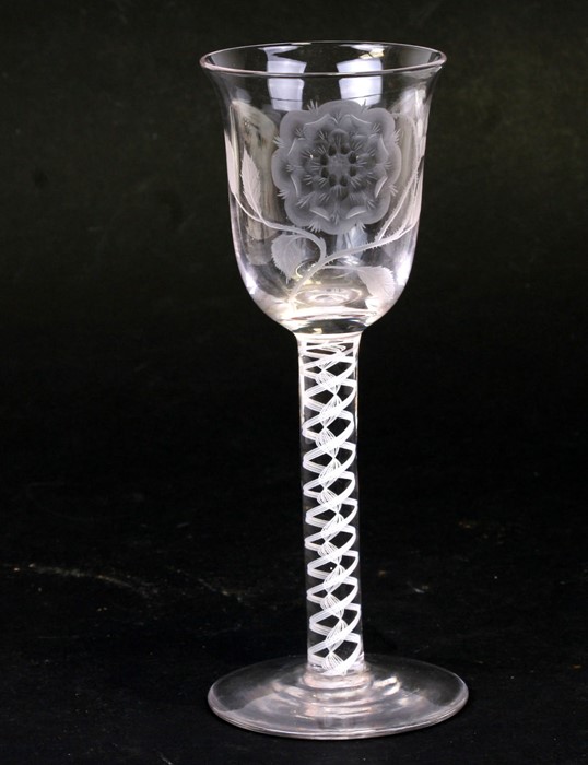 An 18th century style air twist stem wine glass, the bowl etched with an English rose, the stem with