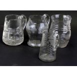 A group of four etched and cut glass jugs, the largest 17cms (6.75ins) high.