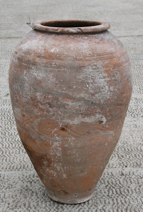 A large terracotta olive jar, 54cms (21.25ins) high.